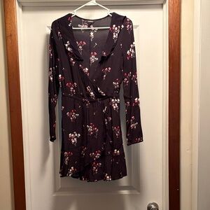 Black and floral dress. Overlaps in front for deep V neckline. Flowy skirt style